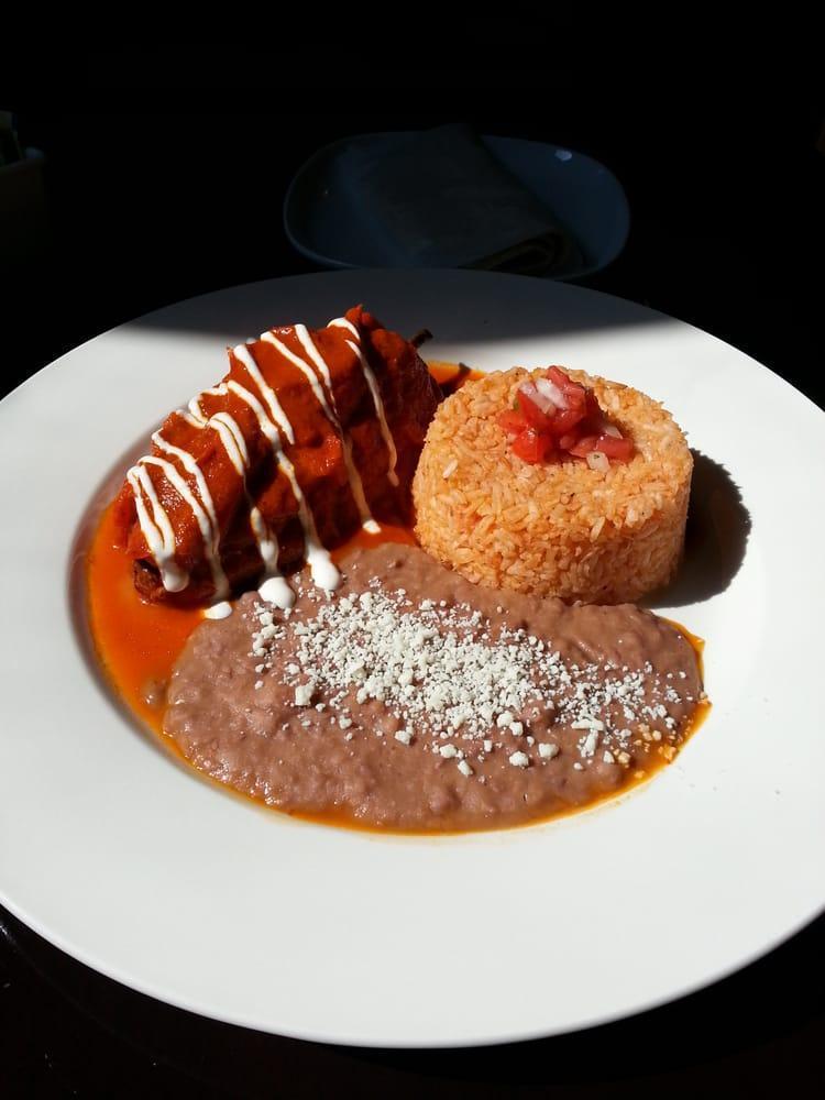 Chile Relleno · Fire roasted poblano pepper stuffed with queso fresco, guajillo-Mexican cinnamon sauce and rice and beans.