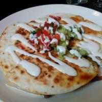 Arrachera Quesadilla · Grilled steak, Applewood bacon, roasted red and poblano peppers and caramelized onions. Incl...