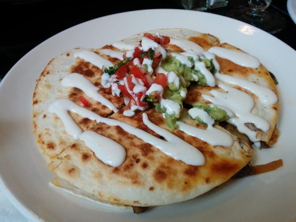 Arrachera Quesadilla · Grilled steak, Applewood bacon, roasted red and poblano peppers and caramelized onions. Includes kermes cheese blend, guacamole, pico de Gallo, sour cream and flour tortillas. 