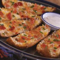 Potato Skins · Crispy potato skins covered with cheese; topped with chives and bacon pieces and served with...