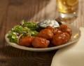 Boneless Bites · Tender chicken breast lightly breaded and tossed in Buffalo sauce. Served with Asian greens ...