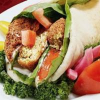 Falafel Wrap · Marinated ground chickpeas with lettuce, tomatoes, cilantro, onion and our special house sau...