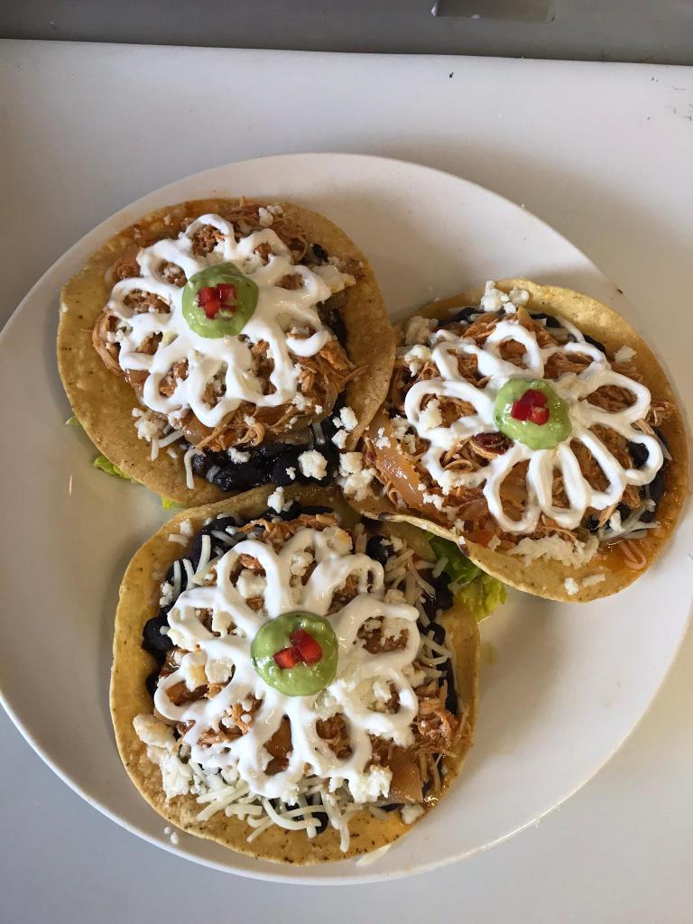 3 Piece Tostaditas · Deep fried corn tortilla topped with beans, salsa, lettuce, sour cream, cheese and guacamole.