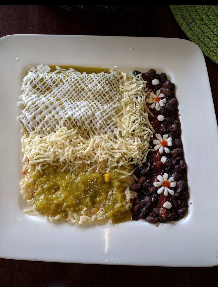 Chicken enchiladas · Rolled corn tortilla with grilled chicken, cheese and habanero salsa, topped with tomatillo salsa, cheese and sour cream. Served with rice and black beans.