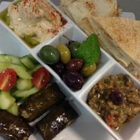 Mediterranean Sampler · Hummus, roasted veggie dip, mixed olives, 2 stuffed grape leaves, cucumbers, toasted pita. V...