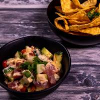 Tuna Ceviche · Sashimi-grade tuna tossed in a soy-lime vinaigrette with avocado, English cucumber and roast...