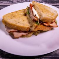 Roasted Turkey Sandwich · Roasted Turkey breast, olive oil marinated bell peppers ,fresh mozzarella, garlic aioli, her...