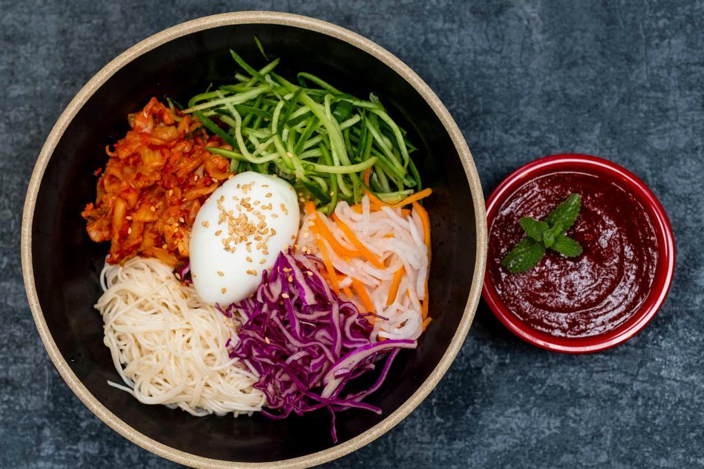 N17. Bibim Noodle · Noodle, cucumber, kimchi, pickled radish, red cabbage, egg, sesame oil and hot sauce. Spicy.