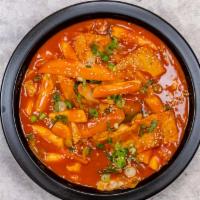Dukbokki · Rice cakes, fish cake, cabbage, carrot, scallion, and sesame in hot sauce. Spicy.