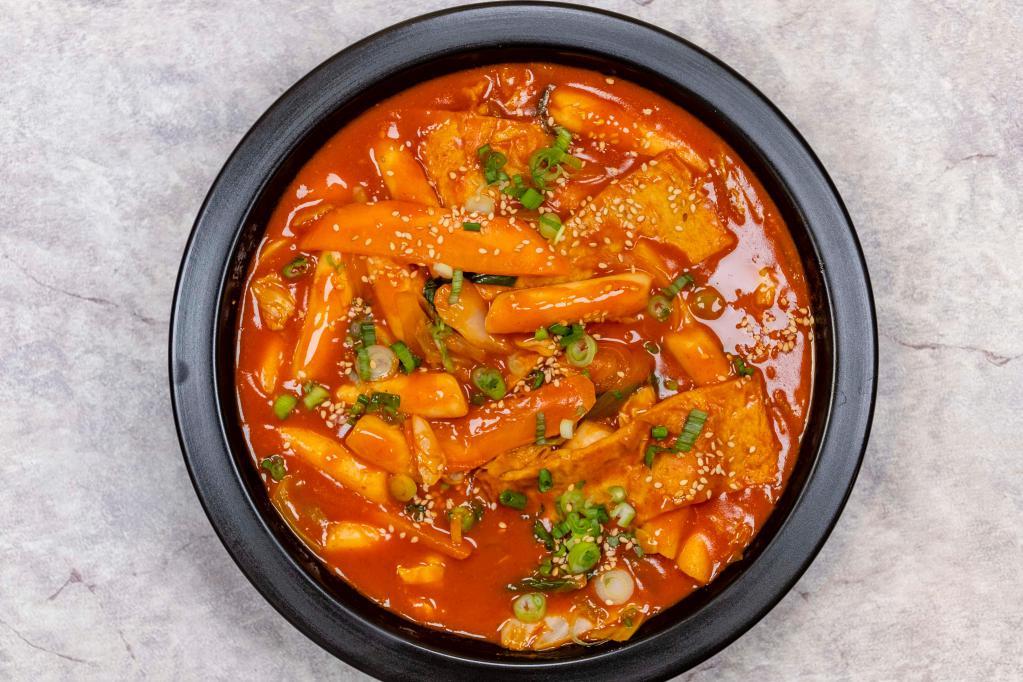 Dukbokki · Rice cakes, fish cake, cabbage, carrot, scallion, and sesame in hot sauce. Spicy.