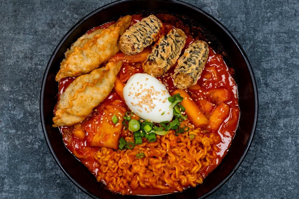 Dukbokki Special · Rice cakes, ramyun, fish cake, cabbage, carrot, scallions, sesame and deep fried- dumblings and seaweed with noodles in gochujang sauce. Spicy.