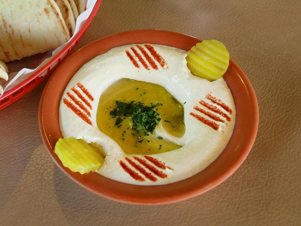 Hummus · Smooth dip of garbanzo beans, tahini sauce and garlic. Topped with olive oil. Served with 2 hot pita bread.