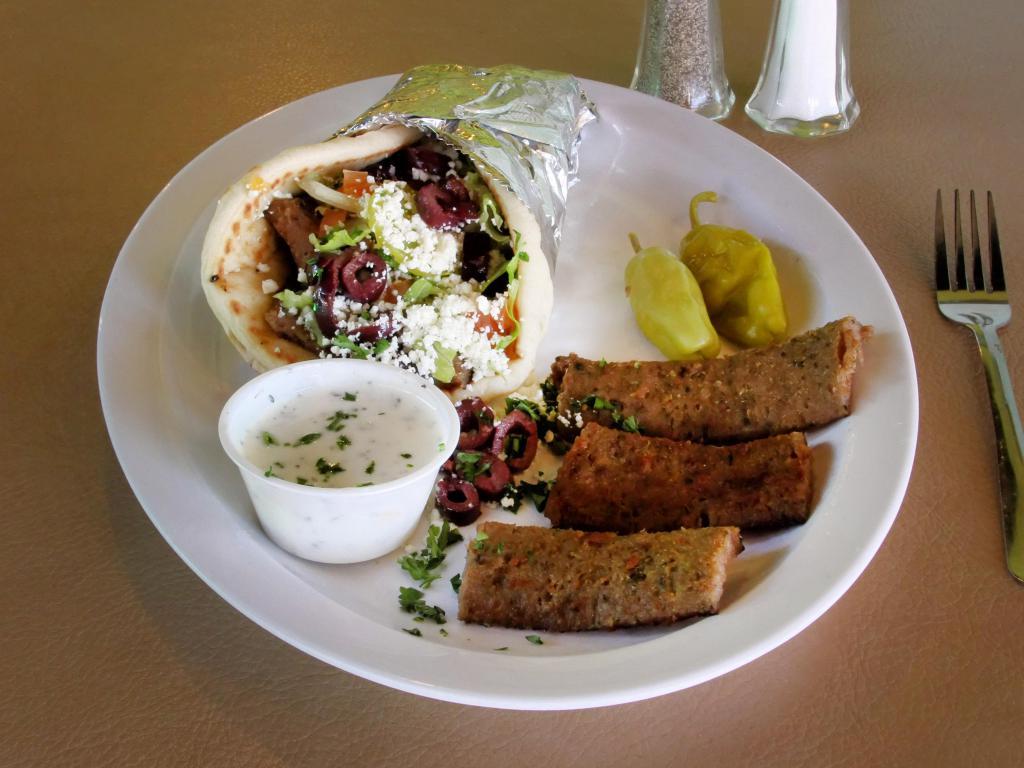 Gyro Sandwich · Gyro meat with lettuce, tomatoes, onion and pickles with cucumber sauce. Wrapped with hot pita bread. Served with fries and drink.