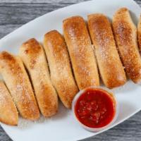 Homemade Breadsticks · Fresh baked breadsticks topped with garlic butter and Parmesan cheese, served with marinara.