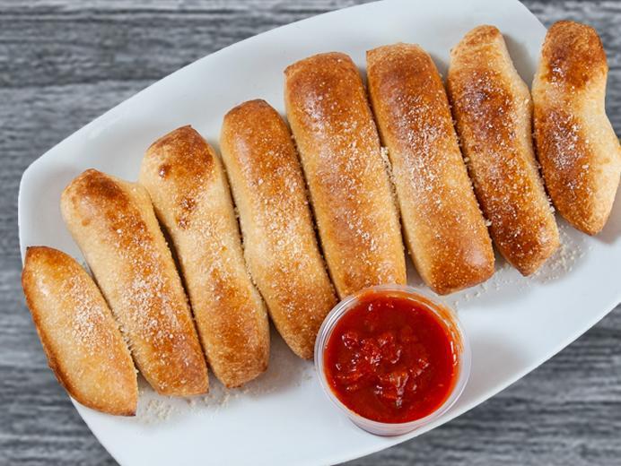 Homemade Breadsticks · Fresh baked breadsticks topped with garlic butter and Parmesan cheese, served with marinara.