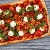 Fresh Mozzarella Pesto Flatbread · Fresh mozzarella, marinara, fresh tomatoes, basil and spicy pesto.