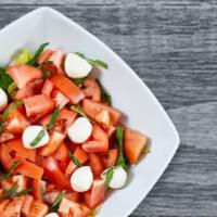 Caprese Salad · Fresh mozzarella, fresh ripe red tomatoes, fresh basil and our house balsamic vinaigrette on...