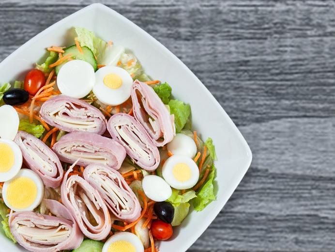 Chef Salad · Ham, turkey, provolone, hard-boiled eggs and Kalamata olives with pits over our tossed salad without mozzarella. Comes with our house vinaigrette.