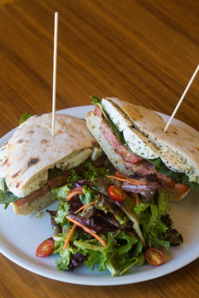 Caprese panino · Housemade fresh bread toasted in our wood-burning oven, Fresh mozzarella cheese, tomatoes and Italian basil with a choice of truffle potatoes chips or mix green salad on the side