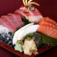 9 Piece Sashimi Sampler · Raw fish sashimi. Served with miso soup and salad.