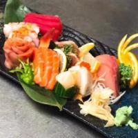 19 Piece Sashimi Deluxe · Raw fish, octopus, squid, surf clam and scallop. Served with miso soup and salad.