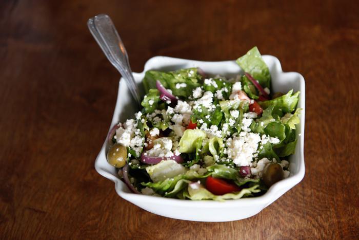 Traditional Greek Salad · Romaine, tomatoes, olives, feta and onion.