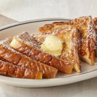 French Toast · 6 pieces of French toast sprinkled with powdered sugar and one syrup container.