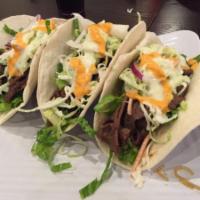 Korean Tacos · Spicy Chicken or marinated ribeye over three warm flour
tortillas filled with crisp lettuce ...