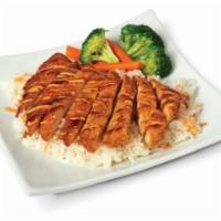 Chicken Katsu · Breaded chicken cutlet served over a bed of steamed rice and vegetables on the side, drizzle...