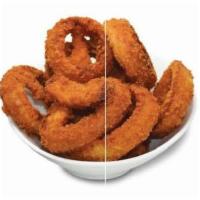Onion Rings · Thick slices of onions in a crunchy batter. Served golden brown with a side of ketchup.