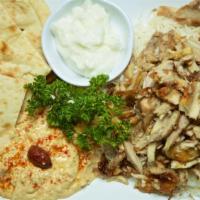 Chicken Shawarma Plate · Served with rice, charbroiled tomato, salad, bread, hummus, and salad.