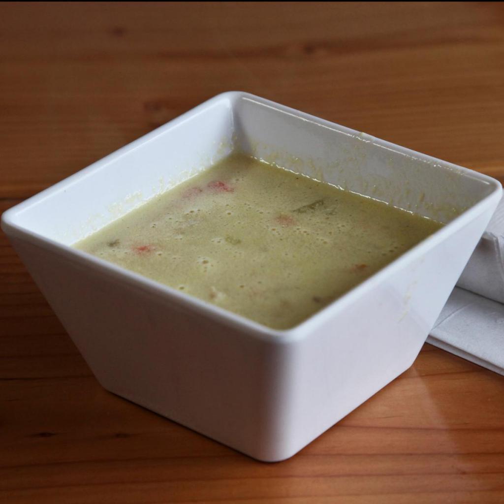 Chicken Lemon Soup · Creamy lemon soup with chopped chicken, rice and egg served with pita bread.