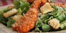 Buffalo Chicken Salad · Crispy romaine lettuce topped with spicy Buffalo chicken, shaved Parmesan cheese and our her...
