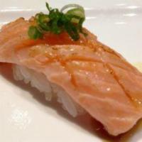 Seared Salmon Toro Sushi · 3 pieces with spicy sweet sauce.
