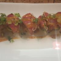 Crazy Tuna Roll · Spicy tuna, crunch and avocado wrap topped with pepper tuna and scallion.
