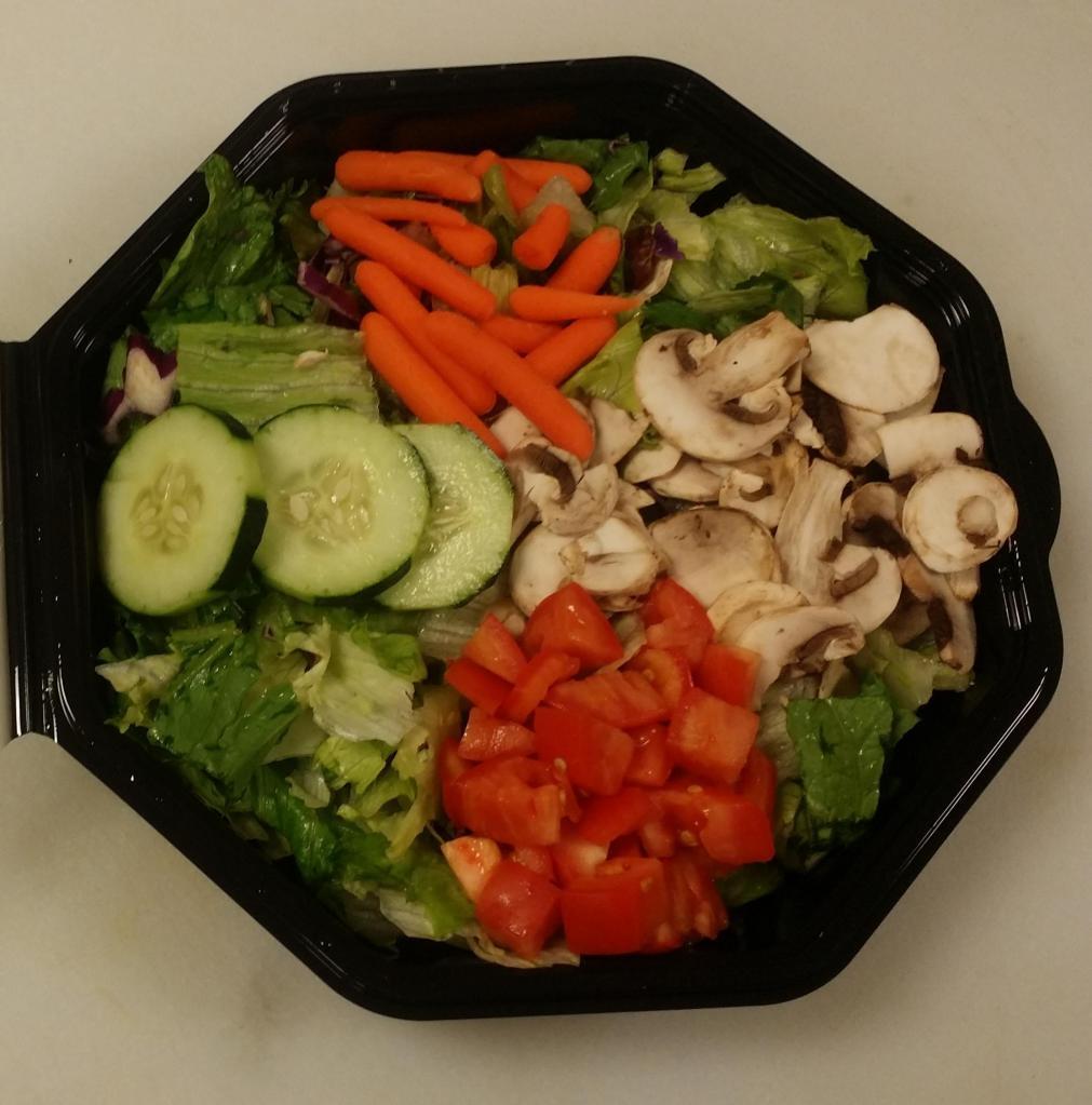 Family-Size Garden Salad · Mixed green salad with mushrooms, tomatoes, cucumbers, carrots and our own garlic Parmesan croutons with choice of dressing.