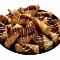 Cinnamon Twists · Rolled in a brown and white sugar-cinnamon mixture and topped with a powdered sugar glaze.