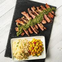 Chimi-Churrasco Steak · This juicy grilled steak is topped with chimichurri sauce. Served with cilantro lime rice an...