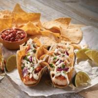 Baja Fish Tacos · Grilled mahi mahi rubbed with Cajun flavors. Served on corn tortillas and topped with shredd...