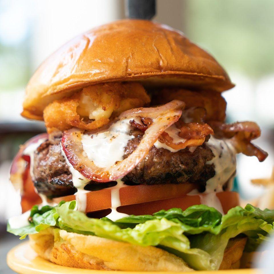 MacDaddy Burger · A truly epic half-pound burger featuring our signature all-beef patty, fried mac n cheese bites, grilled onions, crispy bacon, tomato, lettuce, pickles and topped off with our famous queso.