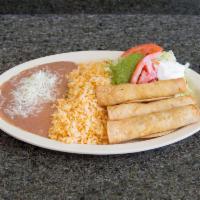 Taquito Dinner Plate · 3 chicken taquitos with lettuce, sour cream and guacamole, served with rice and beans.