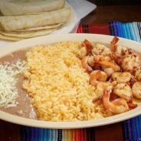 Camarones Al Mojo De Ajo · Shrimp in garlic sauce. Served with rice, beans, lettuce, guacamole and corn tortillas.