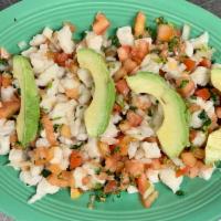 Ceviche Appetizer · Fish and shrimp marinated in lime juice served with avocado slices.