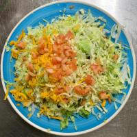 Regular Tostada · Pork, chicken or shredded beef with beans, lettuce, tomatoes and cheese on a crisp flat corn...