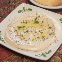 Hummus · Garbanzo beans boiled and blended with tahini sauce, lemon and served with olive oil. Served...