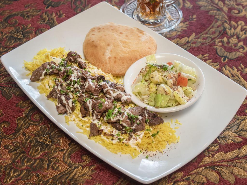 Lamb Shawarma Plate · Marinated strips of lamb. Served with petra salad and basmati rice, drizzled with our homemade petra sauce. Beef or lamb extra. Served with homemade hot pita bread.