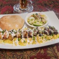 Kabab Mix Plate · Mixed marinated halal beef and halal chicken. Served with petra salad, basmati rice and driz...