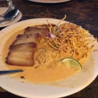 Kao Soi · Steamed egg noodles in savory red curry coconut broth, topped with your choice of grilled ch...