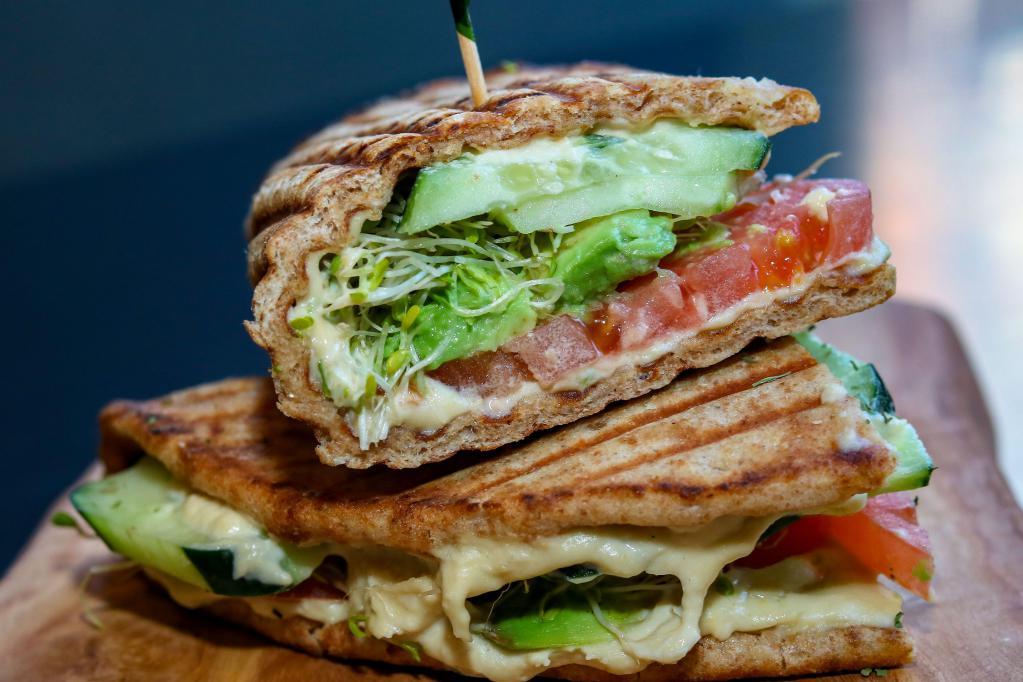 Vegetarian Pita Sandwich · Homemade hummus, cucumber, sliced tomato, avocado and sprouts served on a whole wheat flatbread. Vegetarian. Gluten free.