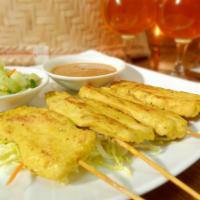 Chicken Satay · Delectable tender chicken skewers sauteed in a blend of Thai spices and coconut cream, serve...